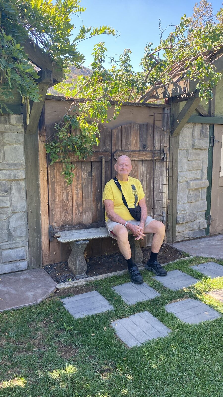 An ATS participant relaxing at a garden gate