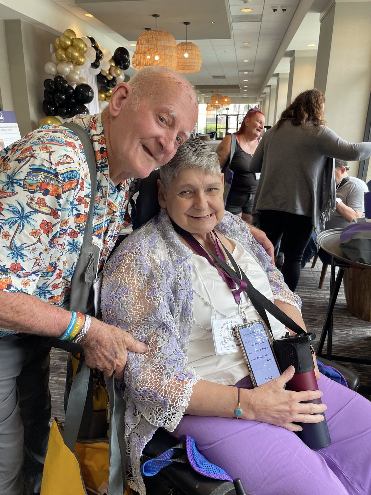 Two ATS participants smiling together at a celebration